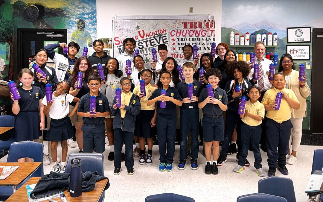 Students pose together smiling for supporting Mission Lazarus and Hope for Haiti's Children - a change collection fundraiser